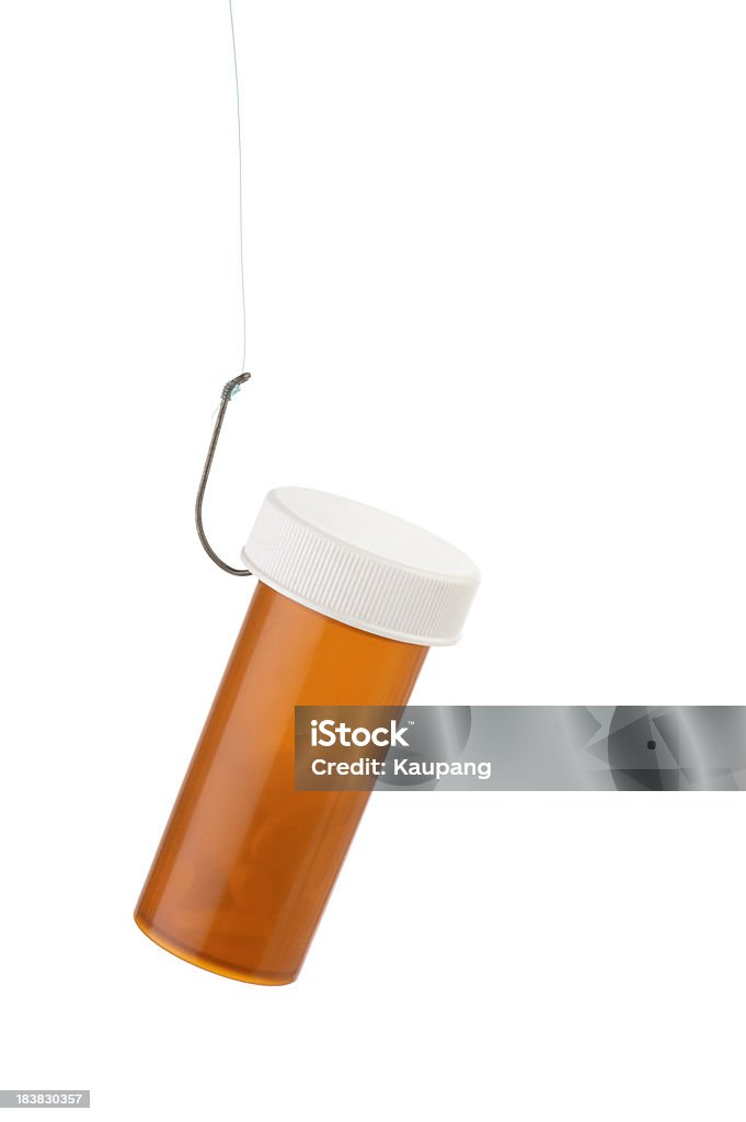 Hooked to Prescription Drugs A prescription bottle hooked to a fishing line isolated on white. Addiction Stock Photo
