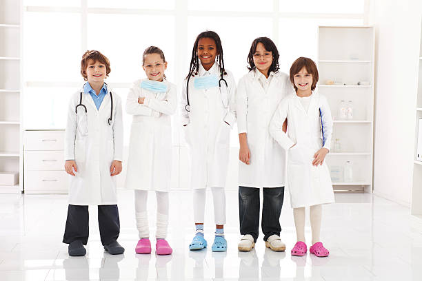 istock Multi-ethnic group of children doctors standing in office. 183831532