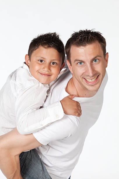 istock Father giving his young son a piggy back ride. 183832179