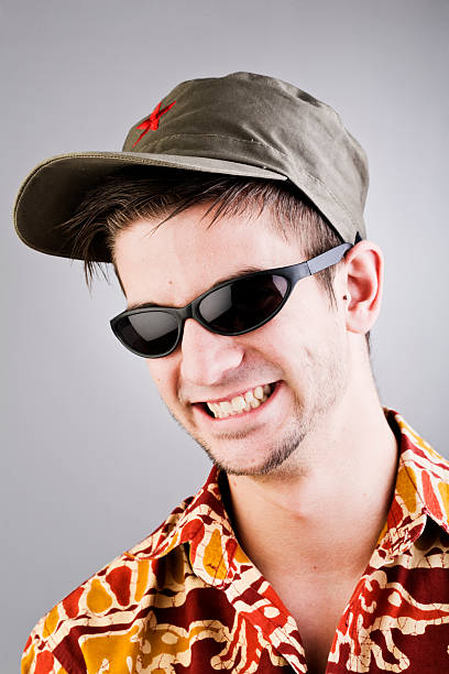 istock Nerd with cap, hawaiian shirt and sunglasses _ vertical. 183832187