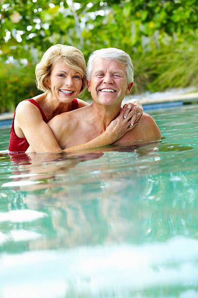 istock Retired couple enjoying themselves in a swimming pool 183832321