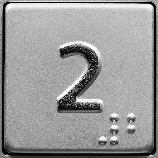 Close-up of metal push button in elevator for 2nd floor