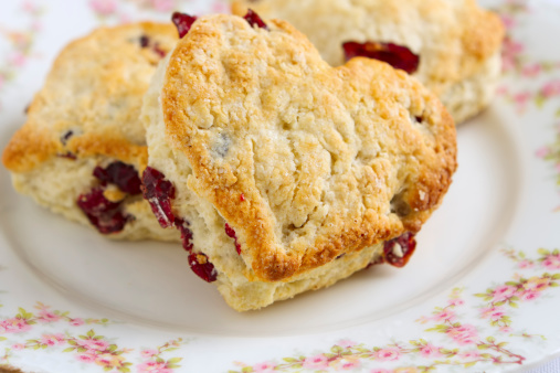 Freshly baked heart-shaped scones with dried cherries.