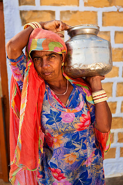 istock Indian woman carrying water from well 183833260