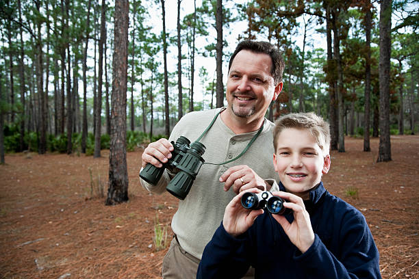 istock Father and son enjoying scenic view with binoculars 183833378