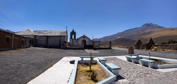 Pampa de Arrieros, Peru, November 6, 2021: View of the church in this Peruvian village at an altitude of 4000 metres. Pampa de Arrieros is called ghost town (pueblo de fantasma) today because the most of the houses are ruined and abandoned.