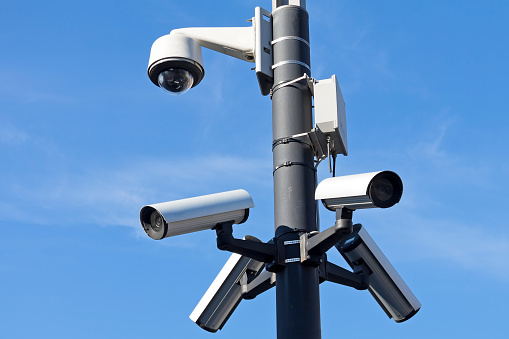 Five surveillance cameras mounted on the pole to control a public place.