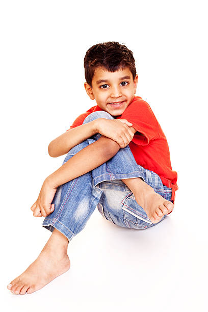 istock One Casual Little Indian Boy Sitting Isolated on White 183834239