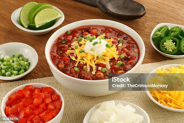 Bowl Of Vegetarian Chili With Ingredients Stock Photo - Download Image Now - Bean, Bowl, Cheddar Cheese