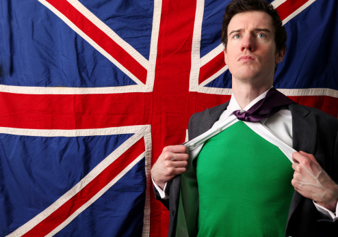 Male against Union Jack background rips open shirt to show green top