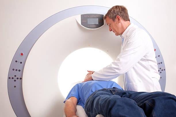male patient in radiology scanner docotor adjusting patient ambulant patient stock pictures, royalty-free photos & images