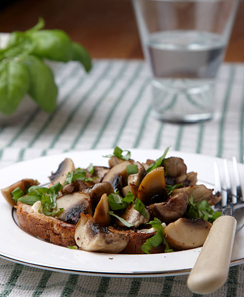 Herby mushrooms on toast Herby mushrooms on toast granary toast stock pictures, royalty-free photos & images