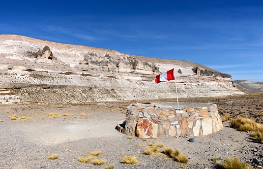 Patahuasi, Peru, November 9, 2021: View of the Peruvian flag in the locality of Patahuasi at an altitude of 4000 meters on a sunny day.