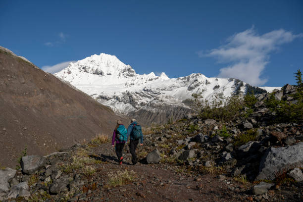 istock Couple hike up mountain path together 1838354103