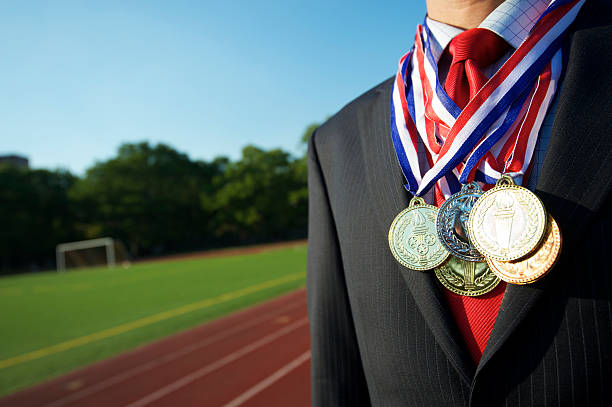 istock Successful Businessman Standing Decorated with Medals by Running Track 183835442
