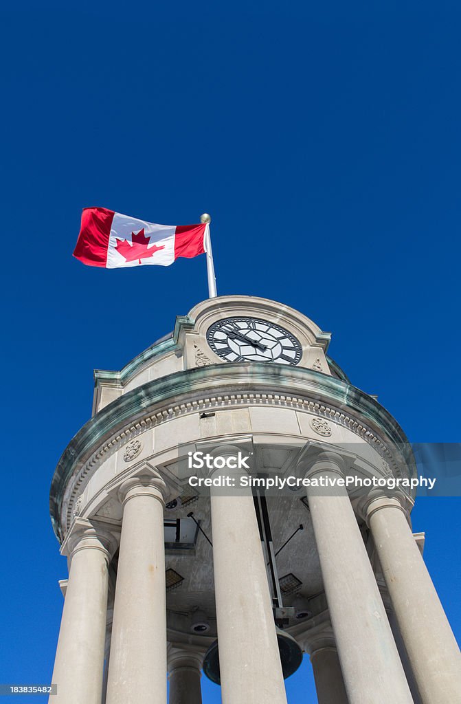 Canadian Flag on Clock Tower The clock tower in Kitchener's Victoria Park with the Canadian Flag against a brilliant blue sky.Similar Images: Victoria Day - Canada Stock Photo