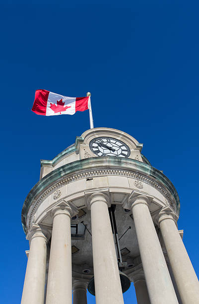 Canadian Flag on Clock Tower The clock tower in Kitchener's Victoria Park with the Canadian Flag against a brilliant blue sky.Similar Images: victoria day canada photos stock pictures, royalty-free photos & images