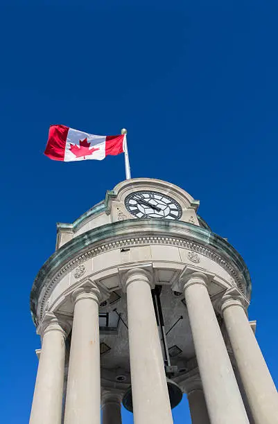 The clock tower in Kitchener's Victoria Park with the Canadian Flag against a brilliant blue sky.Similar Images: