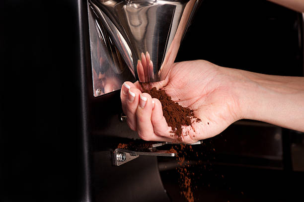 istock Female Hand catching coffee grounds from a grinder 183836095