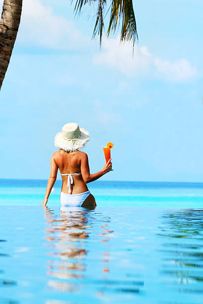 istock Woman drink cocktail on the beach 183836396