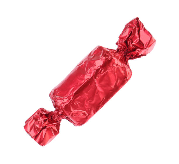 istock Tasty candy in red wrapper isolated on white 1838364283