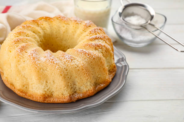 istock Delicious freshly baked sponge cake on white wooden table, closeup. Space for text 1838367991