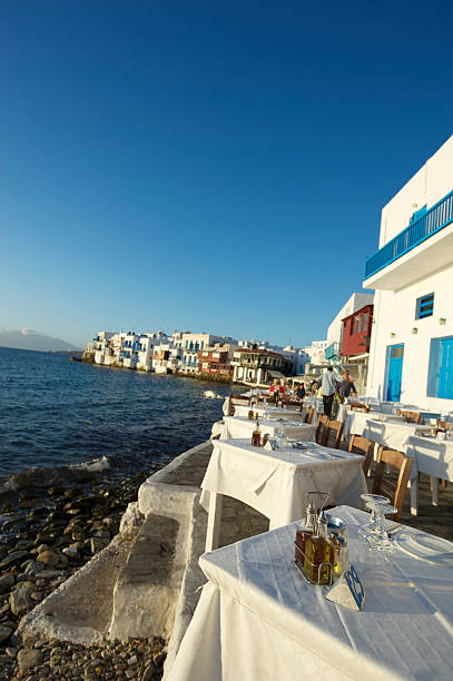 istock Mykonos Harbourside Outdoor Cafe Tables Stand Ready for Dinner 183836993