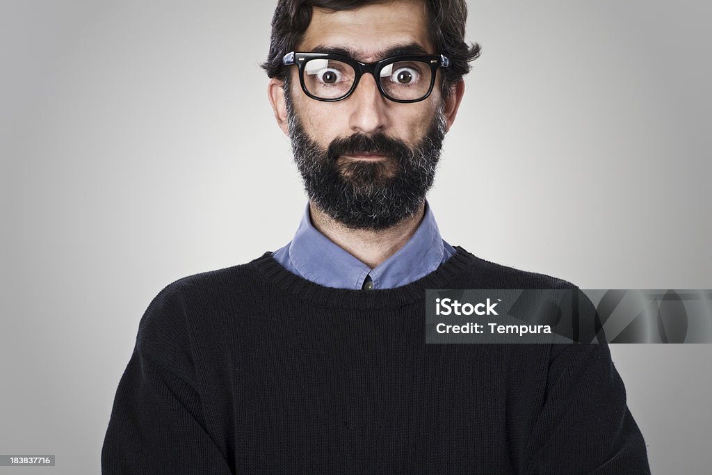 Middle aged man with heavy rimmed glasses One middle aged man looking at camera. He is wearing a black sweater and heavy rimmed glasses, looking at camera.One middle aged man looking at camera. He is wearing a blue shirt and heavy rimmed glasses, standing with his arms crossed over his chest. Bizarre Stock Photo