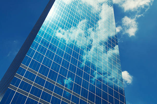 istock Sleek Glass Office Skyscraper Blue Sky Business Reflection 183838703