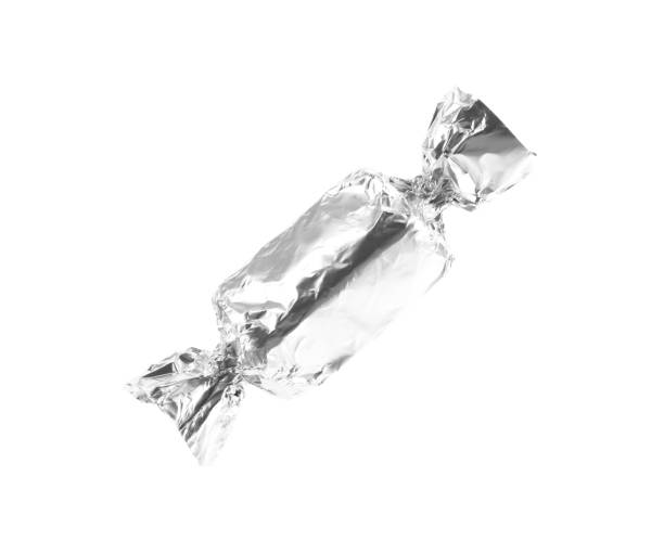 istock Tasty candy in silver wrapper isolated on white 1838387991