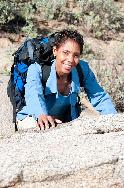 Backpacker Climbing Rock stock photo