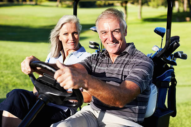 istock Smiling couple in a golf cart 183839346