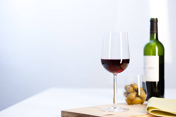 Glass of red wine with bottle stock photo