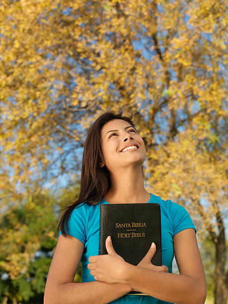 istock Latin woman embracing the Bible 183840342