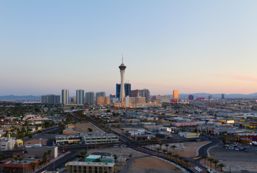 Las Vegas, United States - November 22, 2022: A picture of the STRAT Hotel, Casino and SkyPod, the Las Vegas Boulevard Gateway Arches, and the Chapel of the Bells at night.