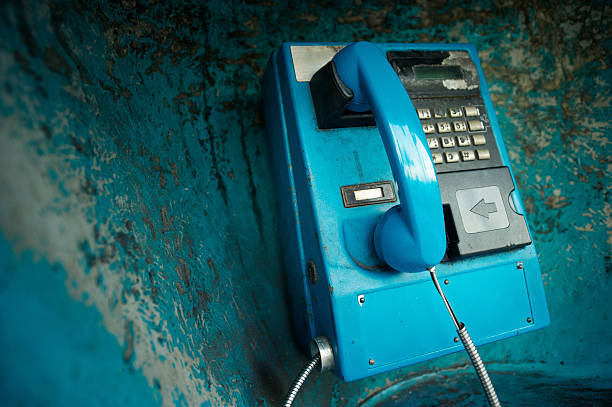 istock Traditional Old Blue Pay Phone w Grimy Background 183841340