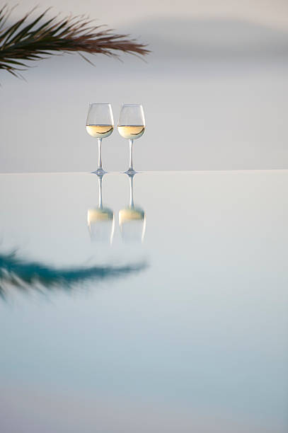 Glasses wine on the edge of a horizon pool