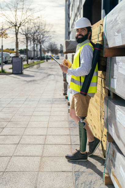 istock Smiling Construction Inspector with Prosthetic Leg Outdoors 1838421118