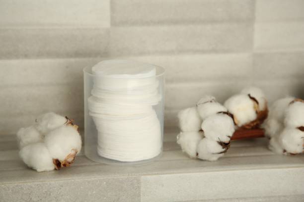 istock Cotton pads and flowers on tiled surface indoors 1838425269