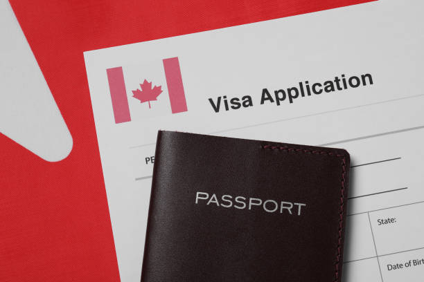 istock Immigration to Canada. Visa application form and passport on flag, flat lay 1838429997