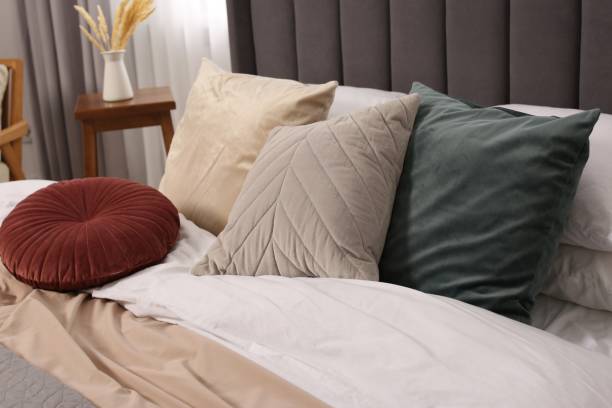 istock Large comfortable bed with soft pillows and blanket in room. Home textile 1838430014