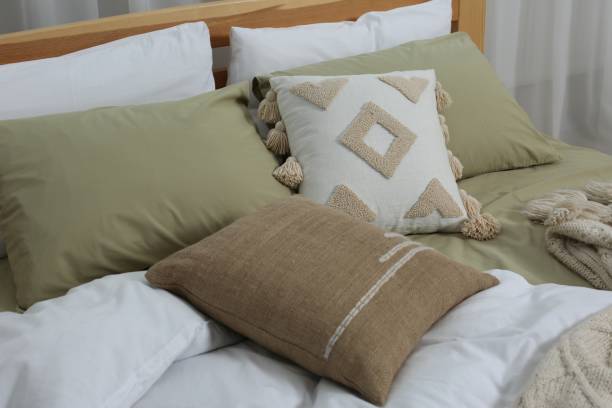 istock Large comfortable bed with soft pillows and duvet in room. Home textile 1838430553