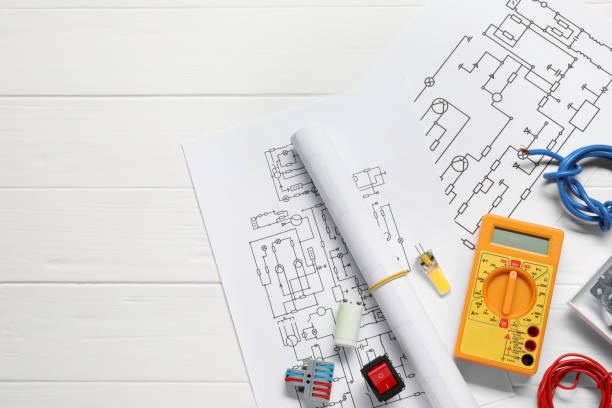 istock Flat lay composition with wiring diagrams and digital multimeter on white wooden table, space for text 1838433734