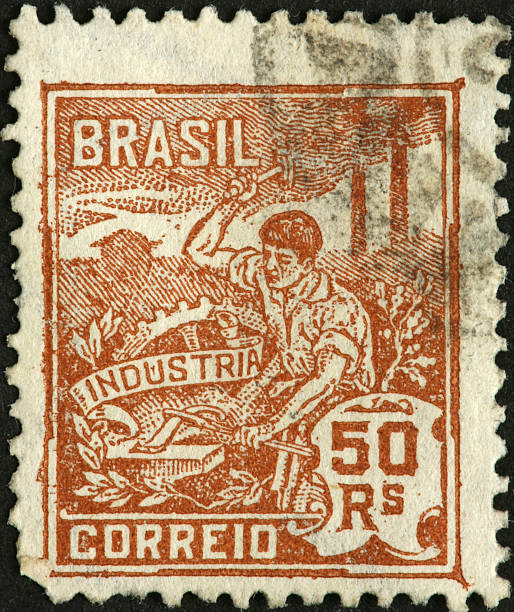 istock blacksmith hammering a machine part on an old Brazilian stamp 183843841