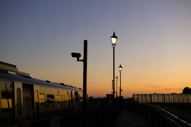 istock a train passes through a station at sunset time as the sun sets 1838440106