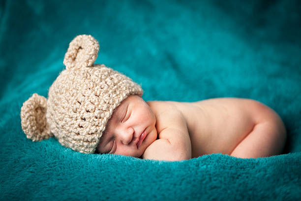 istock Newborn Baby Boy Sleeping Peacefully Wearing Knit Hat 183844425