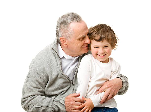 Candid portrait of a happy grandfather and his cute granddaughter.