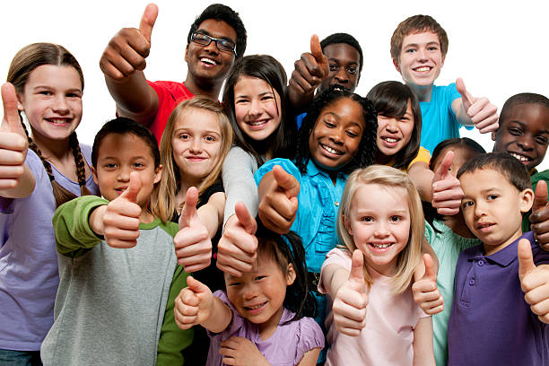 Kids K through 12th grade giving thumbs up A group of K through grade 12 children standing together giving a thumbs up.  The children are all different ages and races.  The children have on purple, blue, red and gray shirts, are all smiling and standing in front of a white background. human age stock pictures, royalty-free photos & images