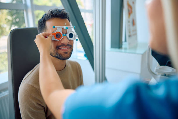 istock Happy man checking his vision at ophthalmological clinic. 1838448515