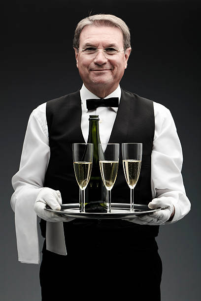 butler con tres copas de champán - waiter butler champagne tray fotografías e imágenes de stock